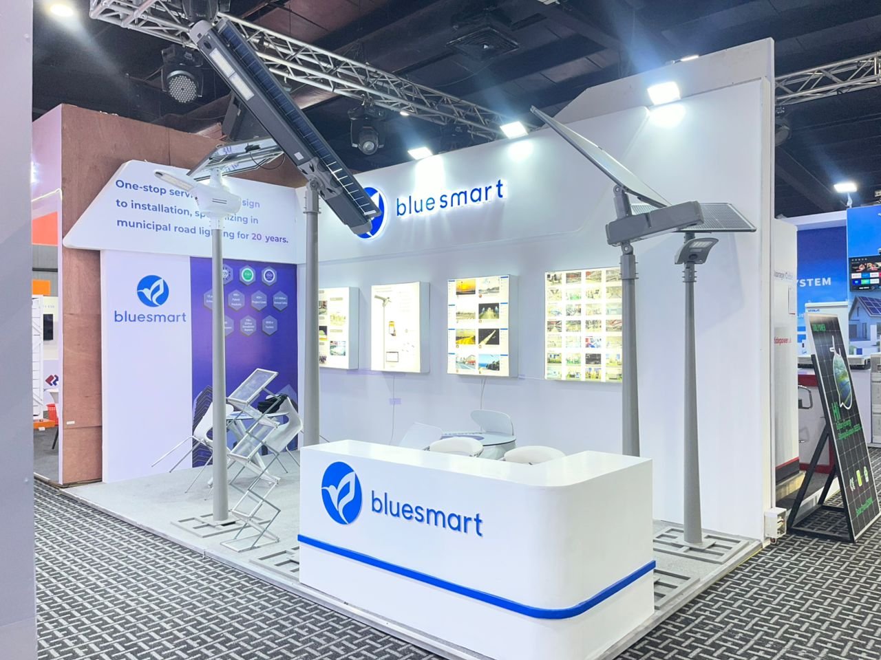 Technology exhibition floor with suspended LED installation and visitors