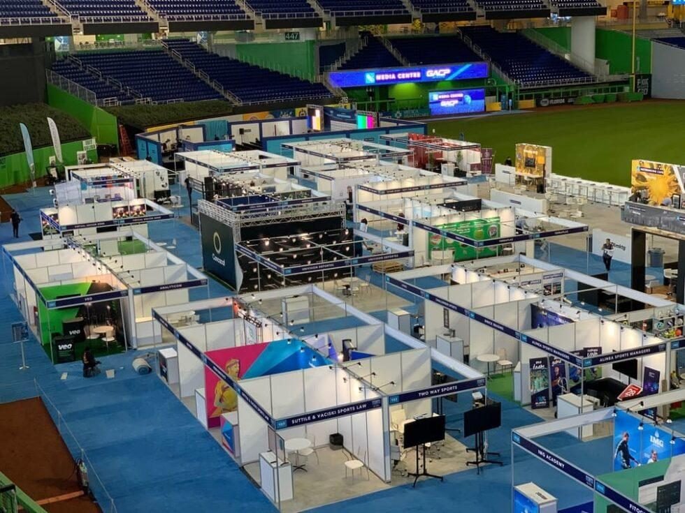 Wide aerial view of an exhibition floor with multiple stands
